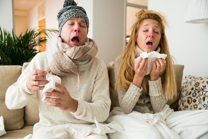 Sick couple catch cold. Man and woman sneezing, coughing, got flu, having runny nose.